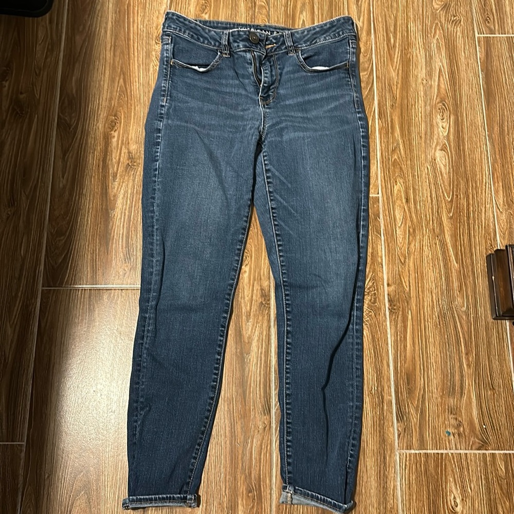 American Eagle dark jeans, small holes on back pockets
